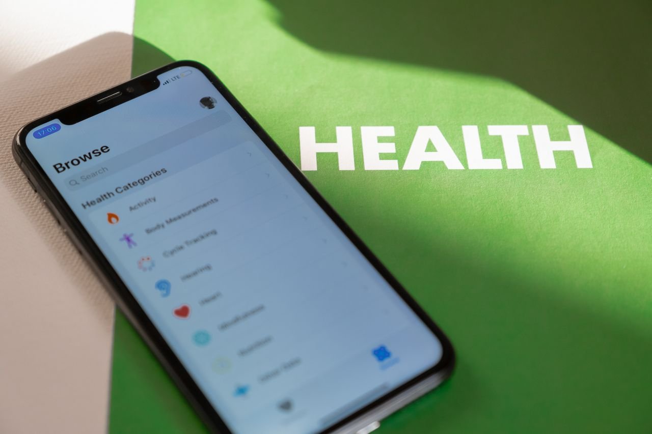 The Art of Drawing Readers In: Your attractive post title goes here Close-up of a smartphone displaying a health app on a green surface with HEALTH text.